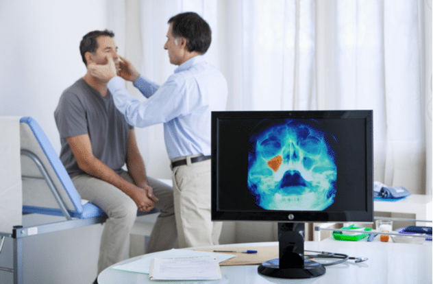 Otolaryngologist examining patients nose at medical office