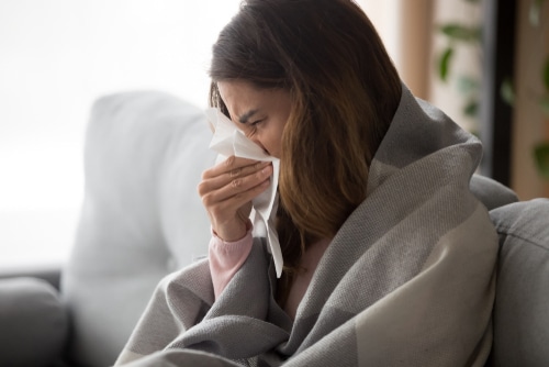 sick girl having influenza symptoms at home