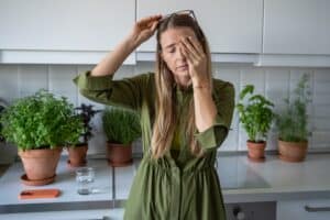 Woman experiencing headache pain from sinus infection in St. Louis, MO